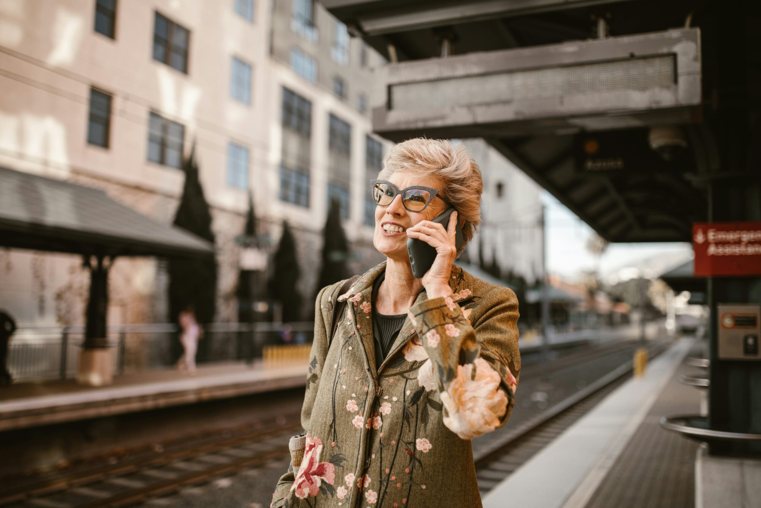 lady on phone at train station