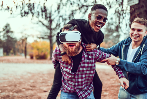 Three men having fun with a virtual reality headset